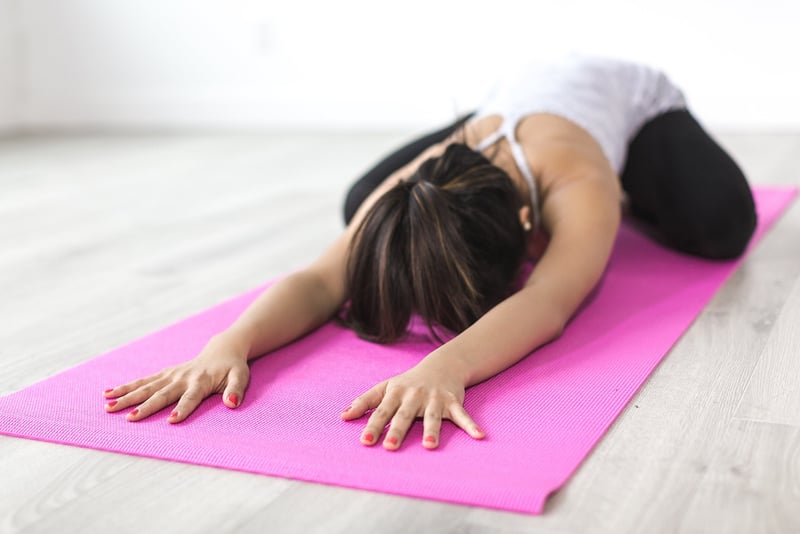 Woman practicing yoga on a retreat